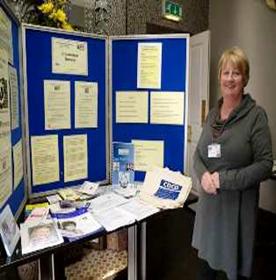 Photo of staff member Sheila and a DAD display stand