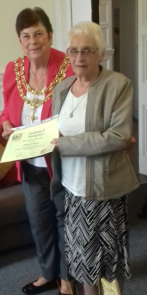 Photo showing Margaret Bond receiving her certificate from Mayor Copeland.