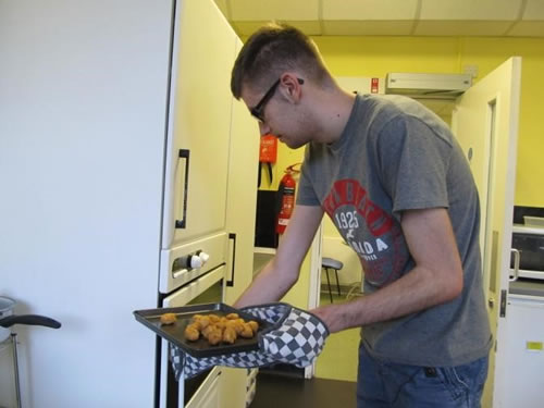 Photo showing Liam making a meal