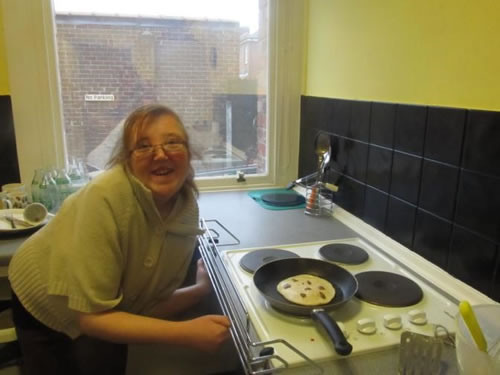 Photo showing Sophie cooking in the Hub kitchen